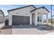 Charming single-story home featuring a grey roof, well-manicured yard and stylish modern farmhouse architecture at 4405 N 203Rd Ave, Buckeye, AZ 85396