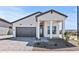 Charming single-story home featuring a grey roof, well-manicured yard and stylish modern farmhouse architecture at 4405 N 203Rd Ave, Buckeye, AZ 85396