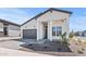 Charming single-story home featuring a grey roof, well-manicured yard and stylish modern farmhouse architecture at 4405 N 203Rd Ave, Buckeye, AZ 85396
