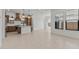 Open-concept kitchen and dining space with modern lighting and neutral tile floors at 4405 N 203Rd Ave, Buckeye, AZ 85396