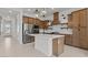 Spacious kitchen featuring stainless steel appliances, a quartz island and custom wood cabinetry at 4405 N 203Rd Ave, Buckeye, AZ 85396