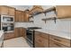 Spacious kitchen featuring stainless steel appliances, a quartz island and custom wood cabinetry at 4405 N 203Rd Ave, Buckeye, AZ 85396