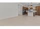 Open-concept living room showcasing a modern kitchen with stainless steel appliances and pendant lighting at 4405 N 203Rd Ave, Buckeye, AZ 85396