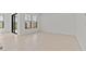 Bright living room features large windows, sliding doors, and tile flooring at 4405 N 203Rd Ave, Buckeye, AZ 85396