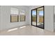 Bright living space with tile floors, white walls, and a large sliding glass door to the backyard at 4405 N 203Rd Ave, Buckeye, AZ 85396