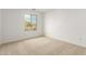 Neutral carpet in a light-filled bedroom with a large window at 11606 W Beck Dr, Youngtown, AZ 85363