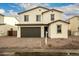 Charming two-story home with a brick driveway, tile roof, and neutral stucco exterior at 11606 W Beck Dr, Youngtown, AZ 85363