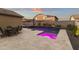 Backyard with a pool, hot tub, desert landscaping, patio, and outdoor dining set at 18428 W Robin Ln, Surprise, AZ 85387