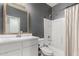 Well-lit bathroom featuring a shower-tub combo, modern vanity, and neutral color scheme at 18428 W Robin Ln, Surprise, AZ 85387