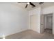 Bright bedroom features modern ceiling fan, carpet, and convenient access to a closet at 18428 W Robin Ln, Surprise, AZ 85387