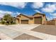 Attractive stucco house boasts a three-car garage, well-kept landscaping, and a welcoming desert-style design at 18428 W Robin Ln, Surprise, AZ 85387