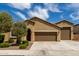 Lovely single-story home featuring a two-car garage, mature landscaping, and a classic desert-style design at 18428 W Robin Ln, Surprise, AZ 85387
