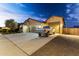Charming home with a well-maintained front yard, long driveway, and spacious three-car garage with pickup truck at 18428 W Robin Ln, Surprise, AZ 85387