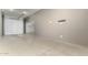 Spacious garage featuring multiple bays, durable flooring, and overhead lighting at 18428 W Robin Ln, Surprise, AZ 85387