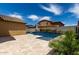 Lush backyard features a private pool with a spa, desert landscaping, and patio area at 18428 W Robin Ln, Surprise, AZ 85387