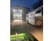 Illuminated barn door open showing the barn's contents, horse trailer on the side at 7706 N 173Rd Ave, Waddell, AZ 85355
