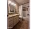 Traditional bathroom features granite counters, tub and shower combo with stylish tile and a neutral color scheme at 7706 N 173Rd Ave, Waddell, AZ 85355
