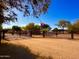A long driveway leads to a home, highlighted by an Arizona state flag and decorative fencing at 7706 N 173Rd Ave, Waddell, AZ 85355