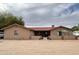 Charming single-story home with a red tile roof and neutral stucco, surrounded by desert landscaping at 7706 N 173Rd Ave, Waddell, AZ 85355