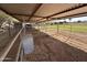 Indoor horse stall or pen with direct access to a large pasture area and outdoor space at 7706 N 173Rd Ave, Waddell, AZ 85355
