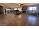 A spacious living room featuring a fireplace, plush leather furniture, and tile flooring at 7706 N 173Rd Ave, Waddell, AZ 85355
