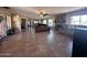 Spacious living room features tile floors, ceiling fans and stone fireplace at 7706 N 173Rd Ave, Waddell, AZ 85355