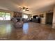 A cozy living room featuring a fireplace, tile flooring, and comfortable leather furniture at 7706 N 173Rd Ave, Waddell, AZ 85355