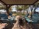 Patio with rocking chairs provides a relaxing outdoor space with views of trees and paddocks at 7706 N 173Rd Ave, Waddell, AZ 85355
