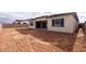 Large backyard with dirt and a view of a tan house at 876 W Golden Ore Pass, Apache Junction, AZ 85120