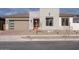 Modern home exterior with stone accents and a two-car garage at 876 W Golden Ore Pass, Apache Junction, AZ 85120