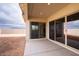Covered patio with sliding glass doors leading to the backyard at 876 W Golden Ore Pass, Apache Junction, AZ 85120