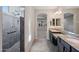 Modern bathroom with dual sinks, granite countertops, and walk-in shower at 27478 W Tonopah Dr, Buckeye, AZ 85396