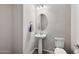 Bathroom featuring a pedestal sink and toilet at 27478 W Tonopah Dr, Buckeye, AZ 85396
