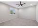 Bedroom featuring a ceiling fan, neutral carpet, and a window with blinds at 27478 W Tonopah Dr, Buckeye, AZ 85396