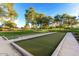Enjoy the outdoors with bocce ball courts, surrounded by lush landscaping and shaded seating areas at 27478 W Tonopah Dr, Buckeye, AZ 85396