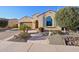 Charming stucco home showcasing a lovely stone walkway, desert landscaping and a two car garage at 27478 W Tonopah Dr, Buckeye, AZ 85396
