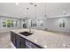 Open concept kitchen with a large island, granite countertops and seamless integration to the Gathering room at 27478 W Tonopah Dr, Buckeye, AZ 85396