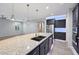 Bright kitchen with a large island, granite countertops, pendant lighting and a large pantry at 27478 W Tonopah Dr, Buckeye, AZ 85396