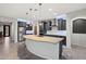 Modern kitchen featuring an expansive island, stainless steel appliances, and sleek dark cabinets at 27478 W Tonopah Dr, Buckeye, AZ 85396