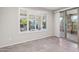 Bright living room with tile flooring, sliding glass doors, and backyard views at 27478 W Tonopah Dr, Buckeye, AZ 85396