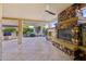 Covered outdoor patio with stone fireplace, built-in grill, and ceiling fan at 27478 W Tonopah Dr, Buckeye, AZ 85396