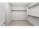 Walk-in closet with carpet flooring, storage shelves and metal clothes racks at 27478 W Tonopah Dr, Buckeye, AZ 85396