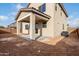 View of the backyard featuring a covered patio and an unfinished yard at 9042 N 116Th Ln, Youngtown, AZ 85363