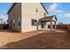 Backyard view of a spacious home with an unfinished yard at 9042 N 116Th Ln, Youngtown, AZ 85363