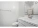 Neutral half-bathroom featuring modern fixtures, a vanity with a sink, and a toilet at 9042 N 116Th Ln, Youngtown, AZ 85363