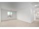 Spacious bedroom with a large window and neutral carpet throughout at 9042 N 116Th Ln, Youngtown, AZ 85363