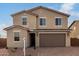 Charming two-story home with a desert landscape, brown stucco, and a large two car garage at 9042 N 116Th Ln, Youngtown, AZ 85363