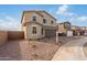A landscaped front yard and a two-car garage can be seen in this shot at 9042 N 116Th Ln, Youngtown, AZ 85363