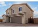 Exterior elevation of a two-story home with a brick driveway at 9042 N 116Th Ln, Youngtown, AZ 85363