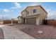 Exterior shot of the home showcasing the garage and a landscaped front yard at 9042 N 116Th Ln, Youngtown, AZ 85363